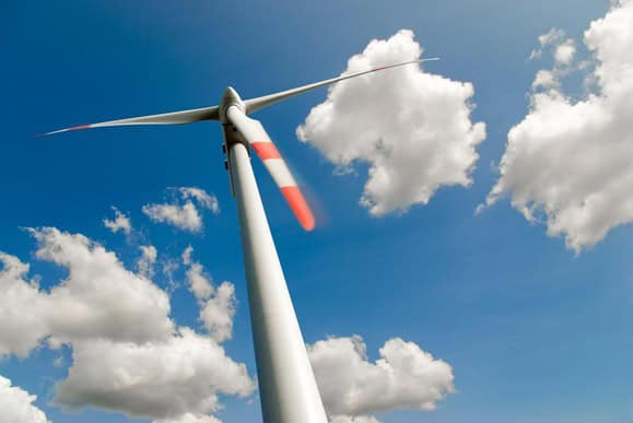 Wind turbine generating clean energy under a blue sky.