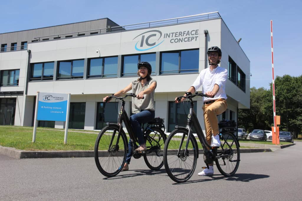 Modern office building of Interface Concept with two cyclists in front.