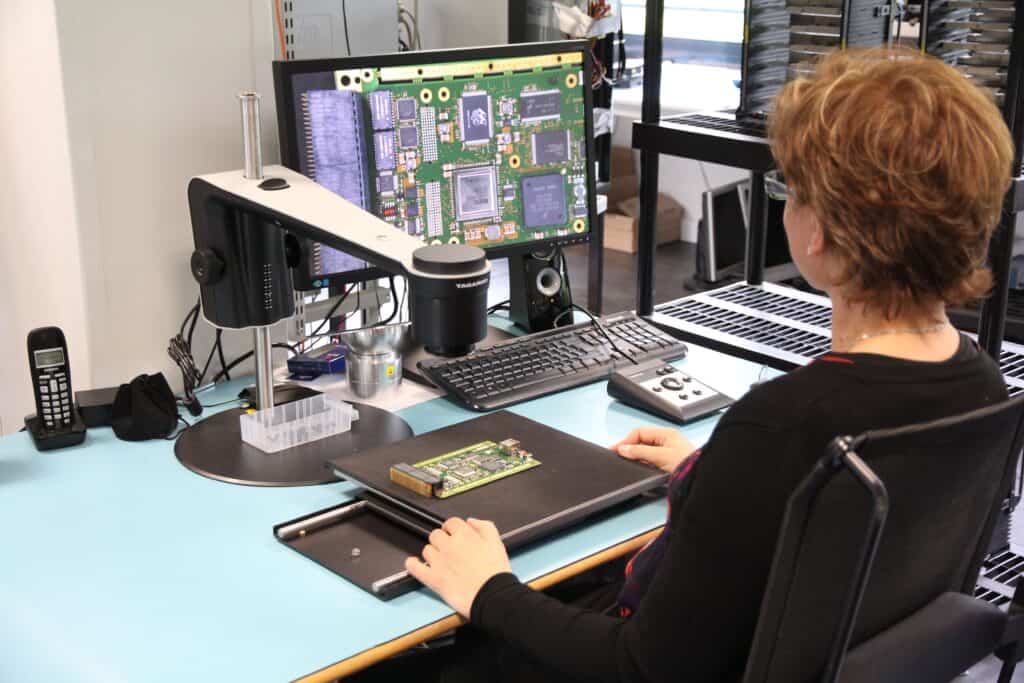 High-tech electronics testing workstation with microscope and circuit boards for quality control and.